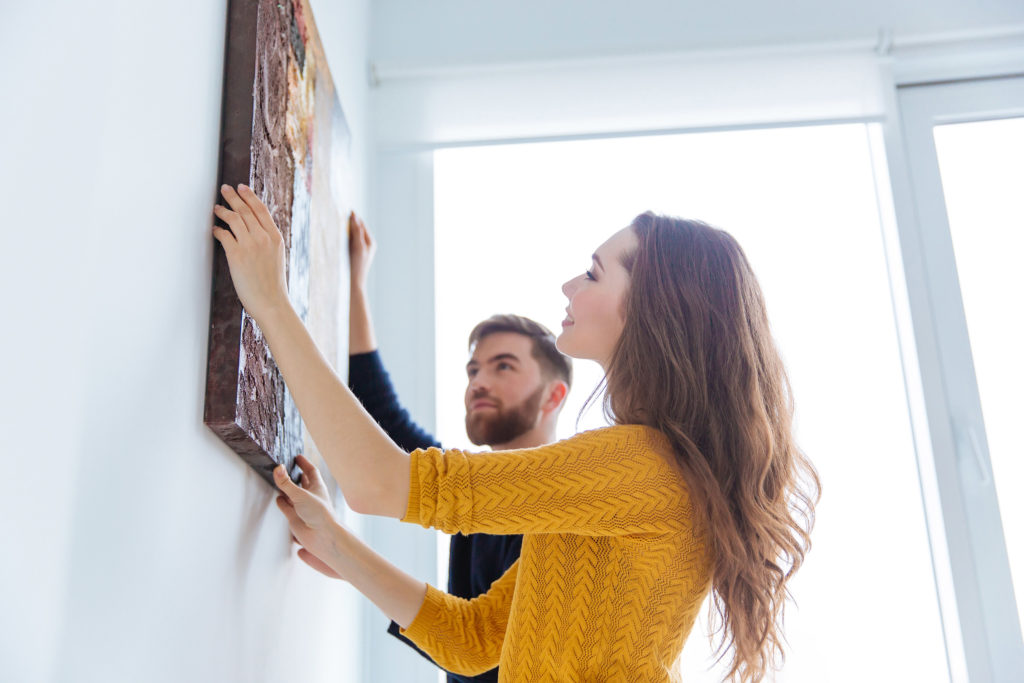 happy couple decorating their new construction home